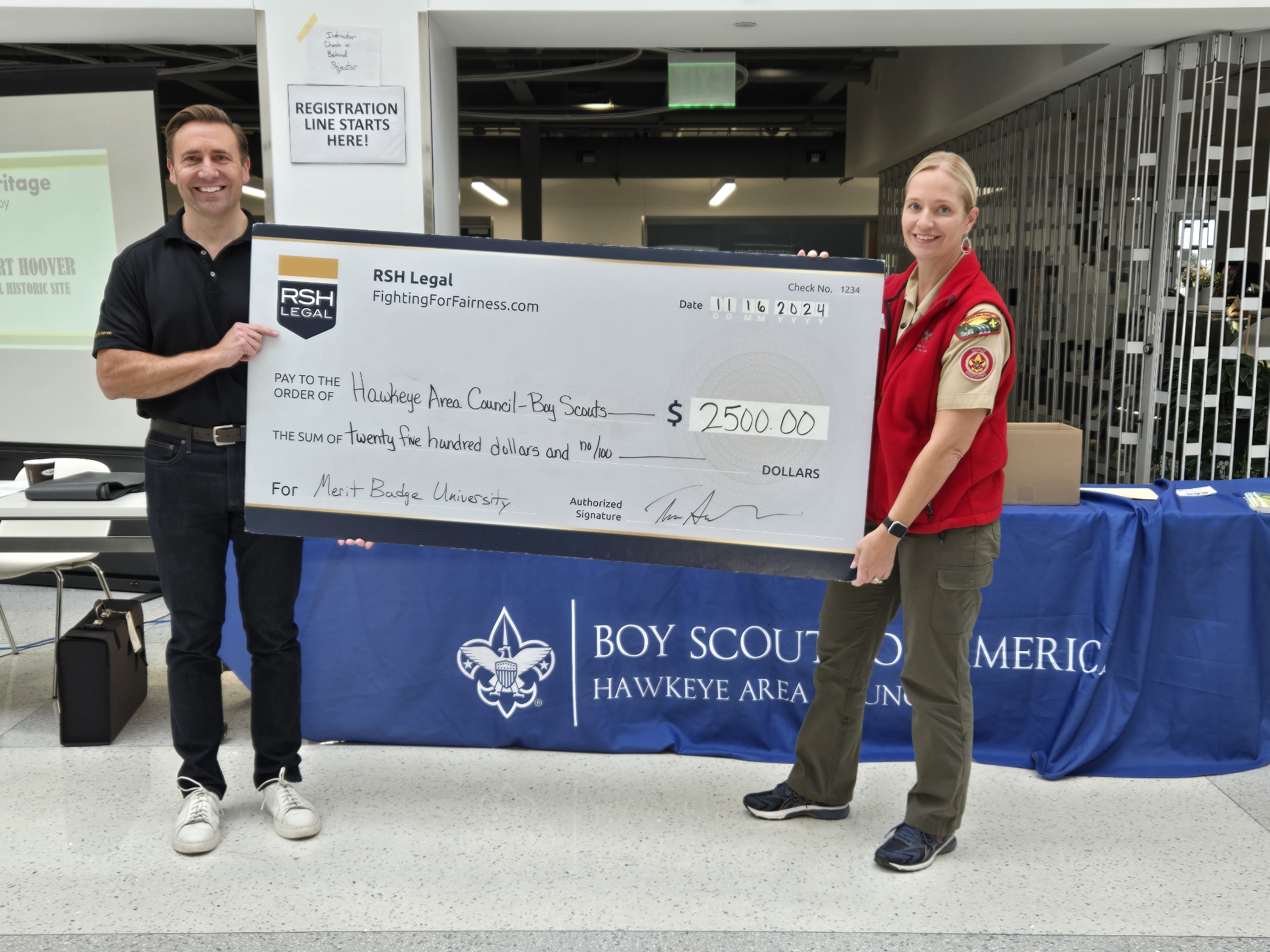 rsh legal iowa truck accident attorney tim semelroth presents a check to sarah dawson with the boy scouts